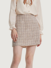 a lady in tweed mini skirt